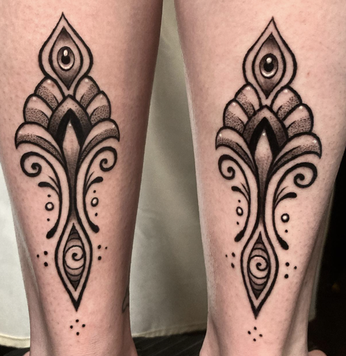 Fine line ornamental tattoo pair